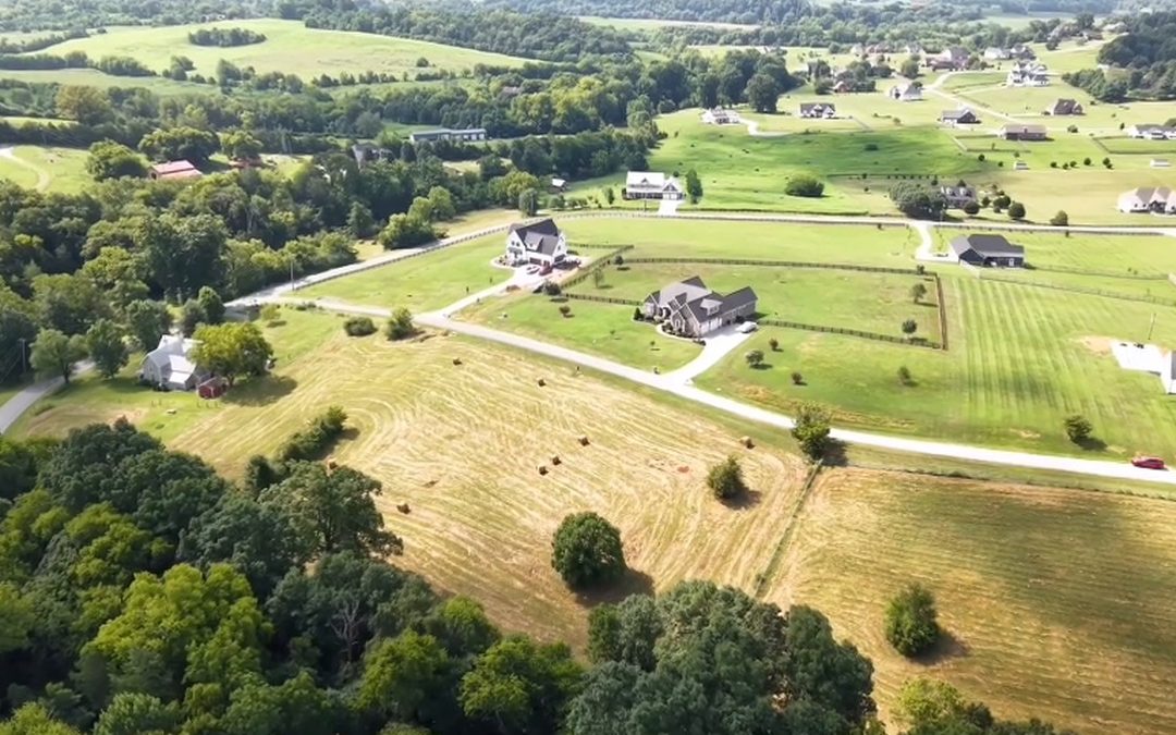 Aerial view of rolling farmland and homes in Blaine, Tennessee
