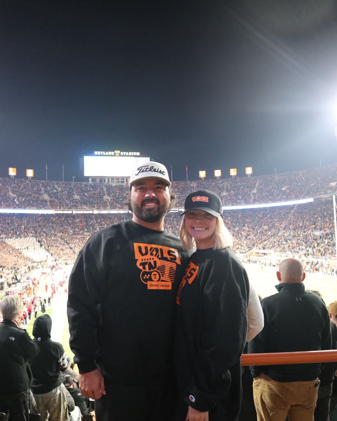 Sara and her husband in Tennessee Volunteers gear at Neyland Stadium on game night